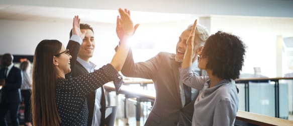 employees hi five in the office