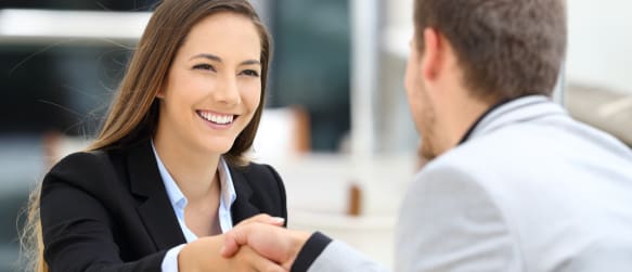 woman shakes hands with new employer