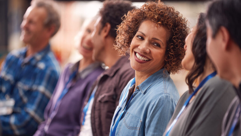 Addison Group's award recognition page, showcasing a woman smiling amongst other people.