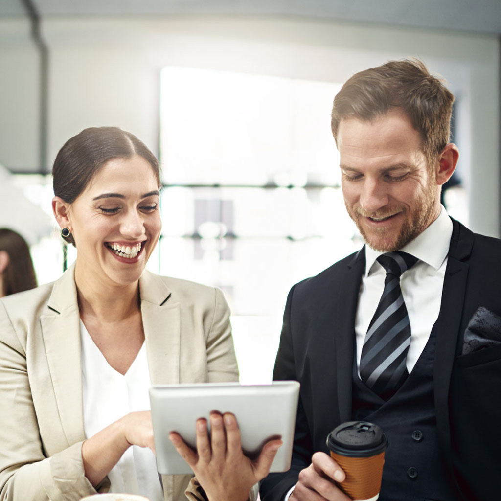 Addison Group's finance and accounting page, two people smiling, looking at a tablet together.