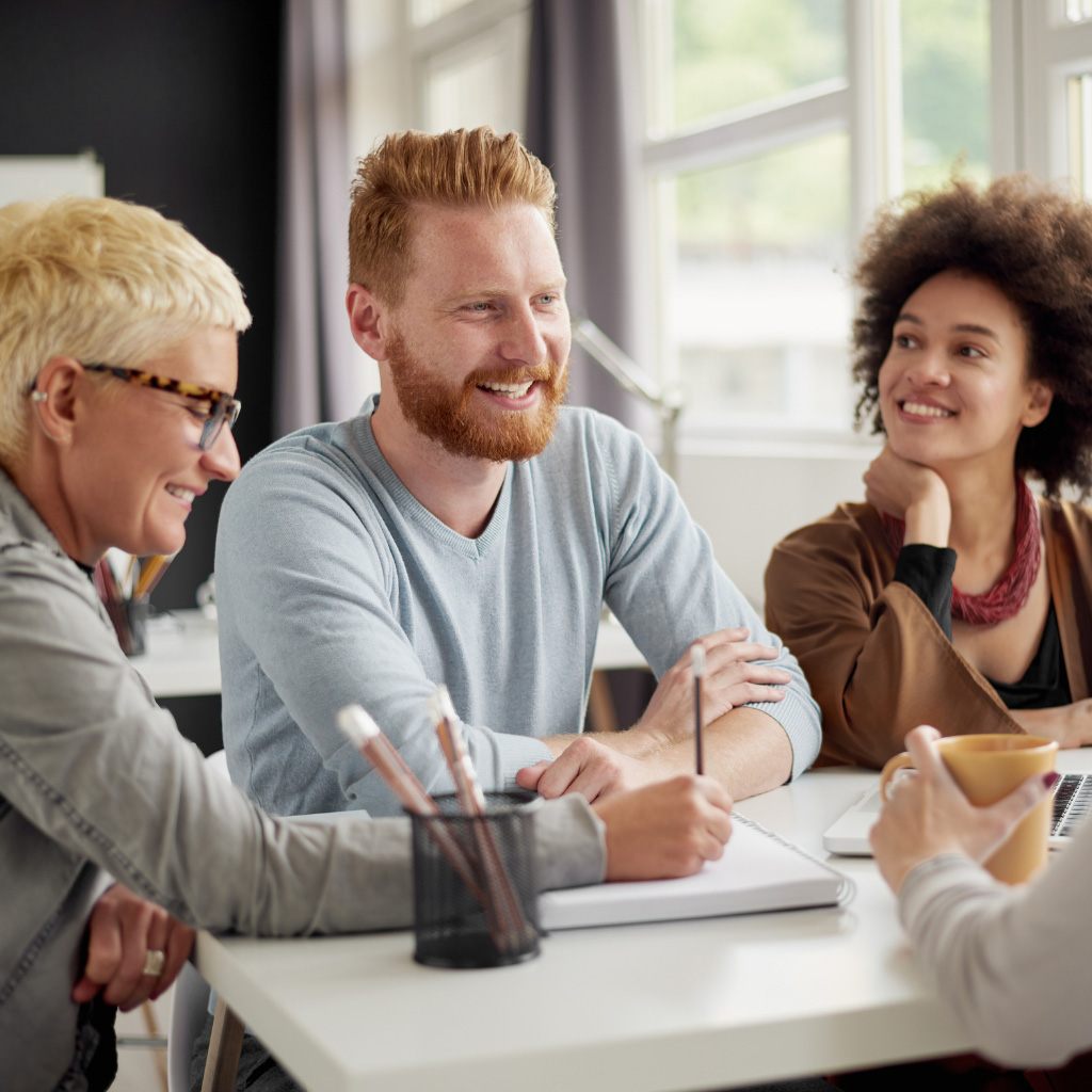 Addison Group's talent solutions page. Three workers talking to each other.