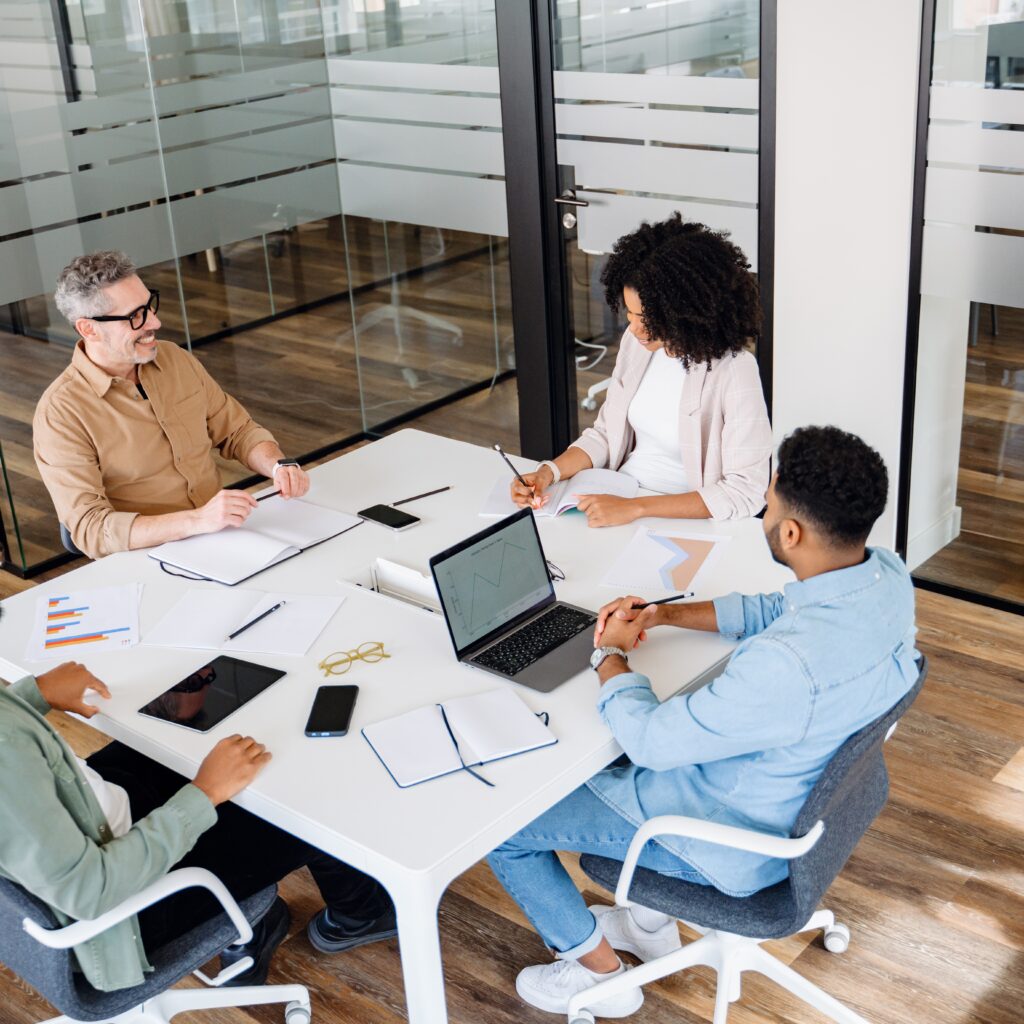 Addison Group Workforce Planning Guide Header Image Featuring Three Workers Around a Table