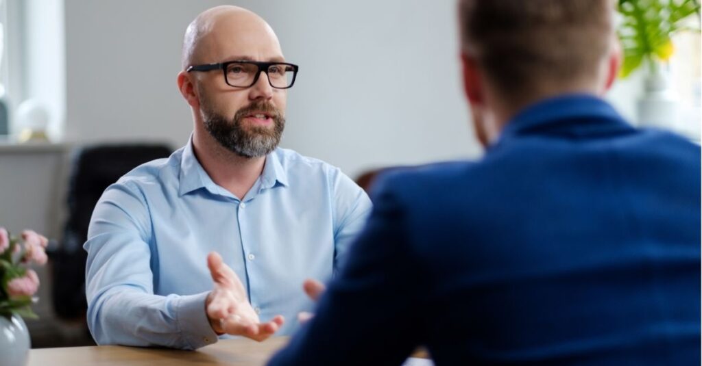 Someone asking their boss for a promotion using Addison Group's tips